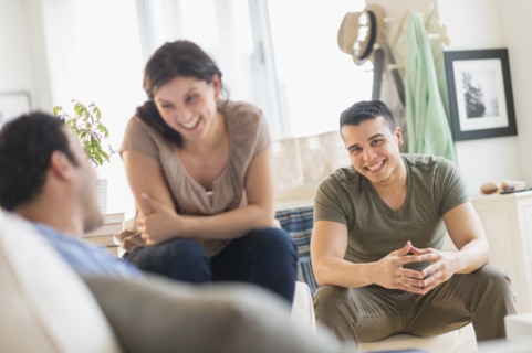 Hispanic friends talking in living room