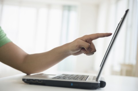 Mixed race man pointing to laptop screen