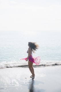 Caucasian woman wading at beach