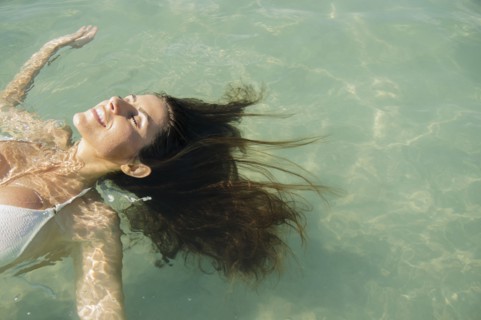 Caucasian woman floating in ocean