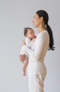 Profile of Asian mother holding baby