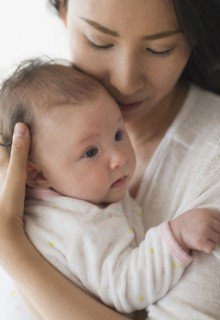 Asian mother holding baby