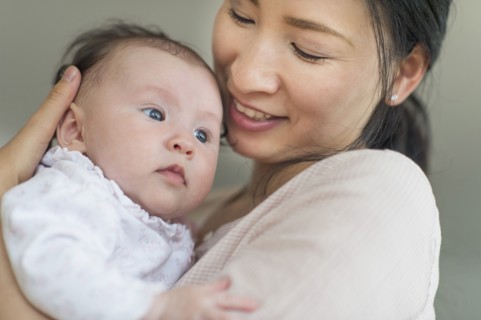 Asian mother holding baby