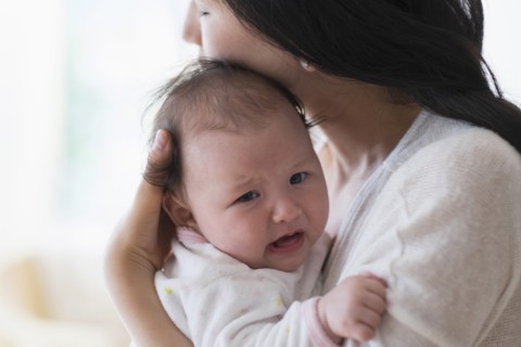 Asian mother comforting crying baby