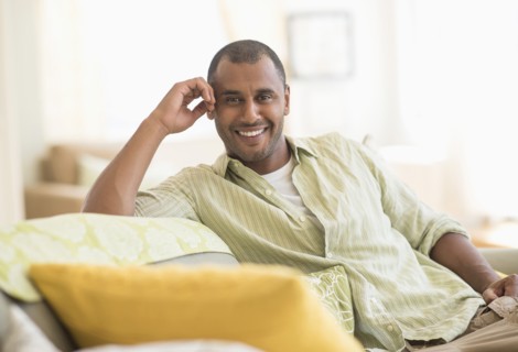 Mixed race man smiling in living room