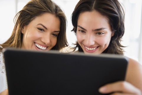 Hispanic women using digital tablet