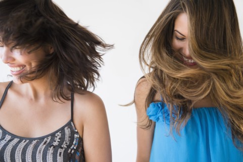 Hispanic women shaking their hair