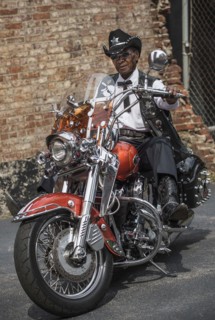 Senior African American man riding motorcycle