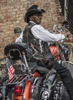 Senior African American man riding motorcycle
