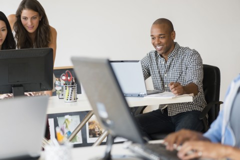 Business people working together on computers in office