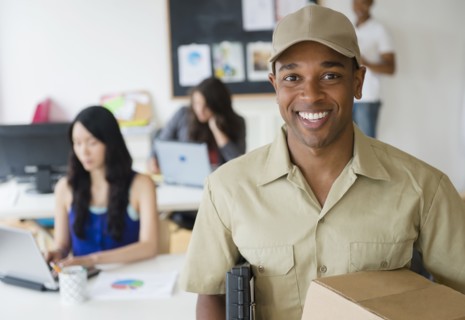 Delivery man smiling in office