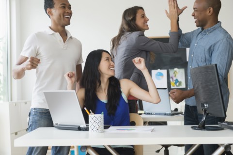 Business people cheering in office