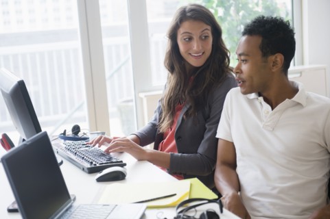 Business people working together on computer in office