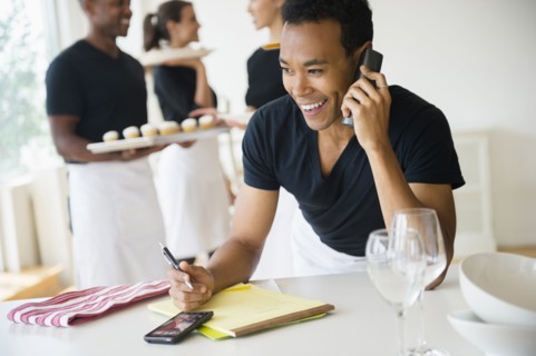 Caterer talking on phone in event space