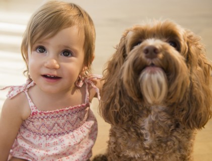 Caucasian girl hugging pet dog