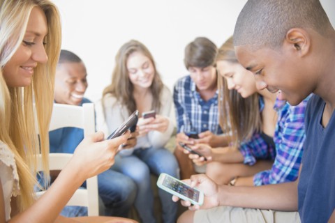 Teenagers using cell phones