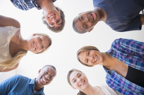 Low angle view of teenagers standing in circle