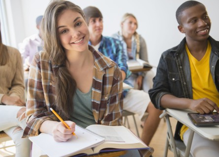 Teenage student smiling in classroom
