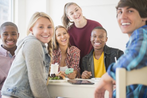 Teenagers smiling at table