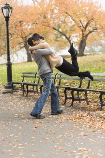 Smiling couple hugging in park