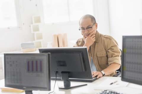Korean businessman working on computer at office desk