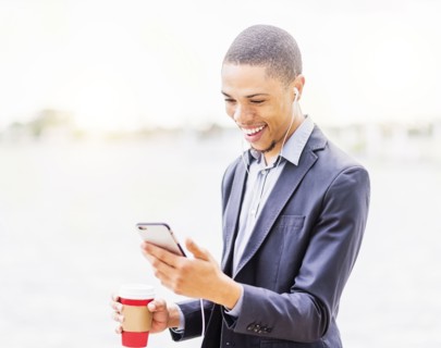 Black businessman using cell phone outdoors