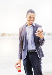 Black businessman using cell phone outdoors
