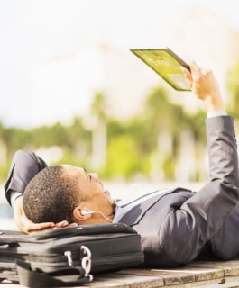 Black businessman using digital tablet outdoors