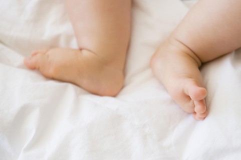 Close up of feet of mixed race baby