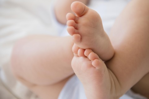 Close up of feet of mixed race baby