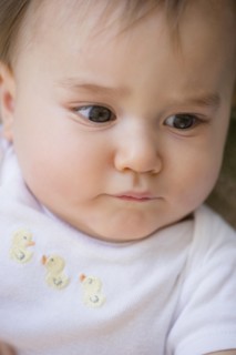 Close up of confused mixed race baby