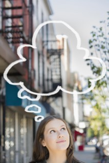 Caucasian woman looking up at thought bubble