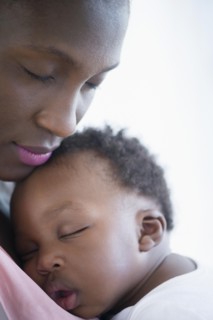 Close up of Black mother holding sleeping son