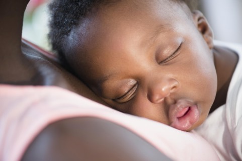 Close up of Black boy sleeping on mother