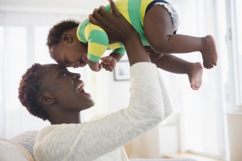 Black mother playing with baby boy