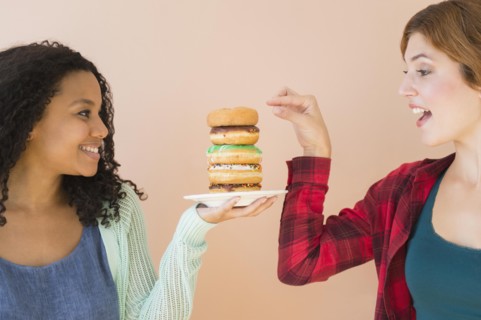 Women enjoying stack of donuts