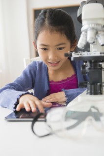 Vietnamese student doing science experiment in classroom