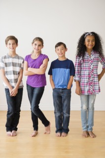 Barefoot children smiling in studio