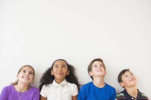 Smiling children thinking and looking up