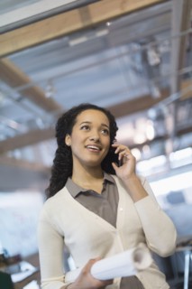 Mixed race architect talking on cell phone