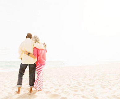 Older couple hugging on beach