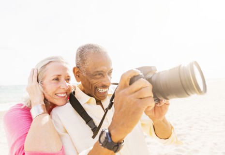 Older couple photographing on beach