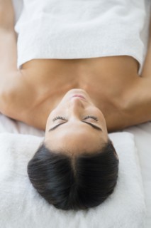 Caucasian woman laying on massage table