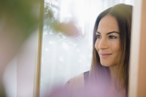 Caucasian woman admiring herself in mirror