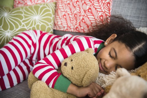 Mixed race girl sleeping on sofa