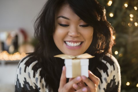 Pacific Islander woman holding small wrapped gift