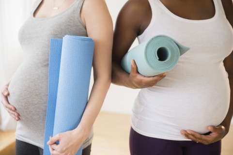 Pregnant women carrying yoga mats