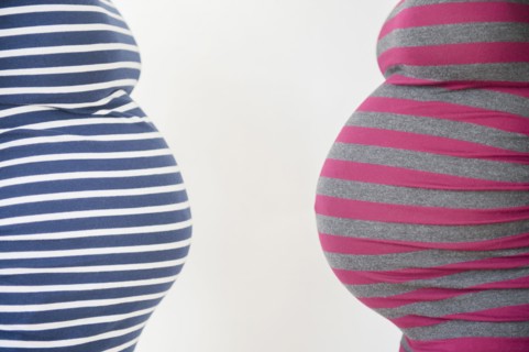 Close up midsection profiles of stomachs of pregnant women