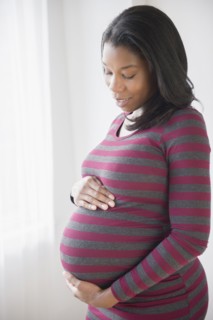 Black pregnant woman admiring her stomach