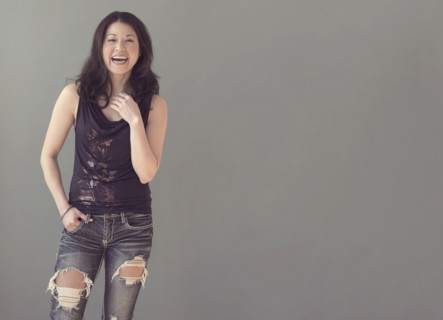 Mixed race woman wearing ripped jeans